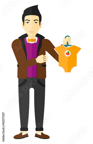Man holding clothes for baby.