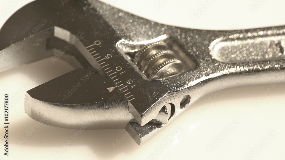 A macro view of a steel adjustable wrench as a technical and repair works concept A macro view of a steel adjustable wrench as a technical and repair works concept