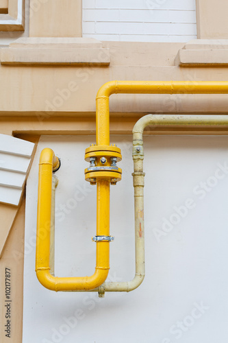 Curves of the gas pipe on the background wall in a classic style