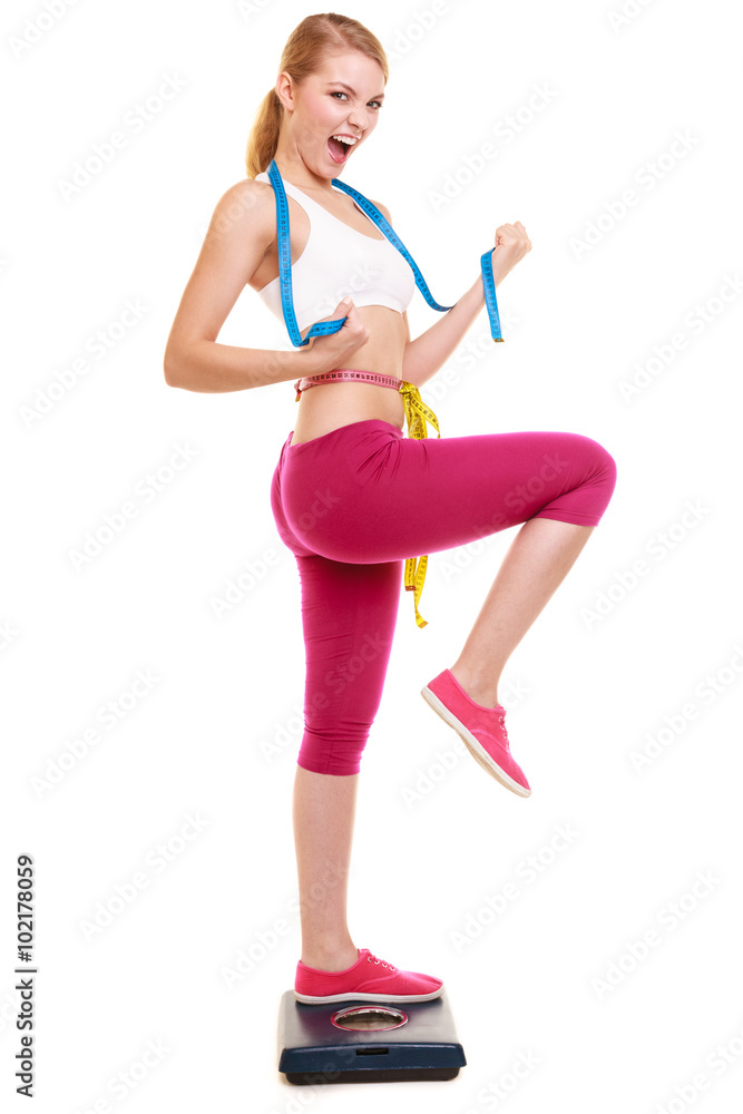 Woman clenching fists measuring on weighing scale. Woman clenching fists measuring on weighing scale.