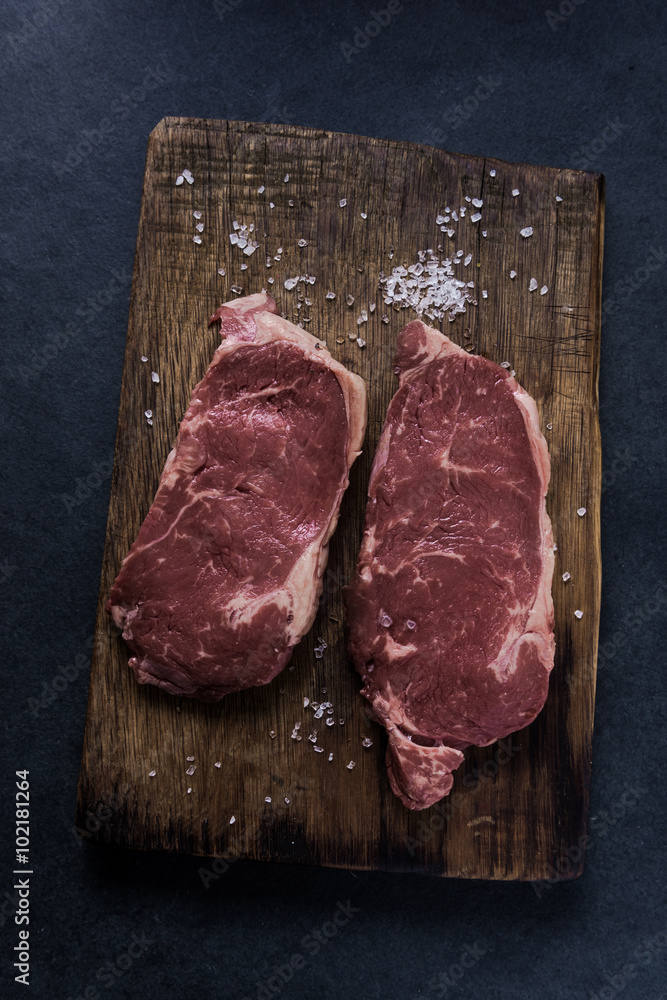 Fresh raw stirlion beef steaks with salt
