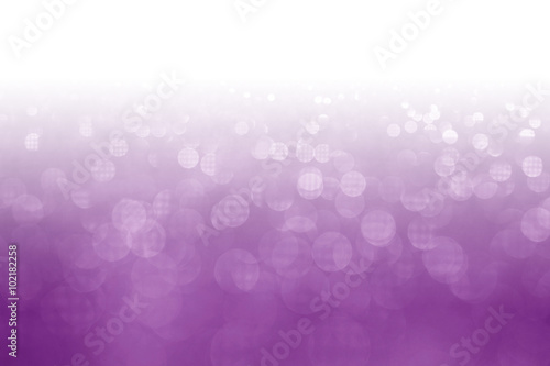 Purple glitter surface with purple light bokeh with white empty copy space