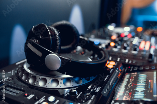 headphones on dj board in night club photo
