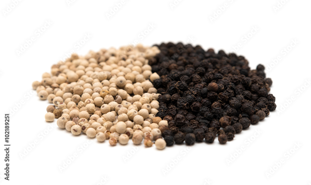 Pile of white and black pepper Pile of white and black pepper