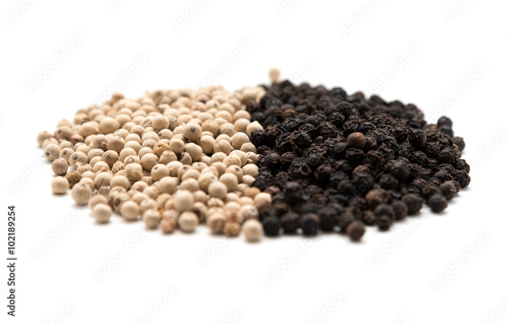 Pile of white and black pepper Pile of white and black pepper