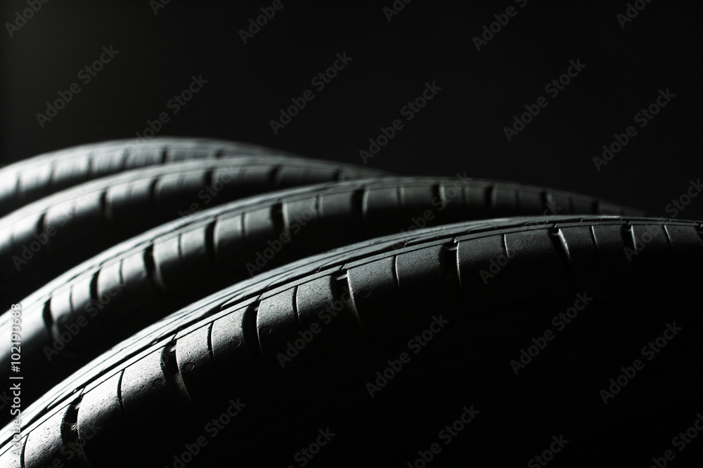 new tires are close to each other on an isolated dark background
