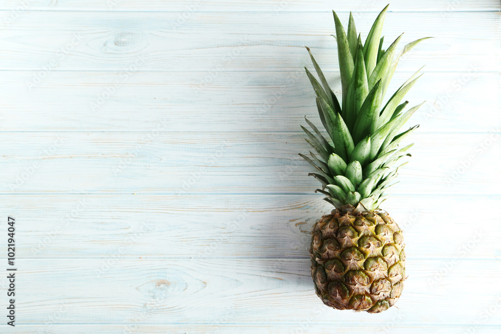 Fototapeta premium Ripe pineapple on a blue wooden table