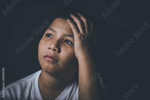 scared and alone, young Asian child who is at high risk of being bullied, trafficked and abused
