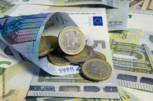 Euro coins on banknotes photo