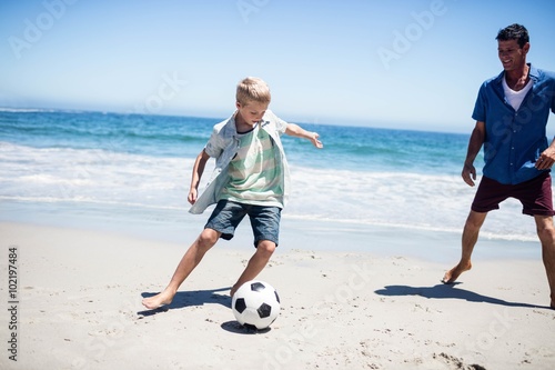 Father and son playing soccer