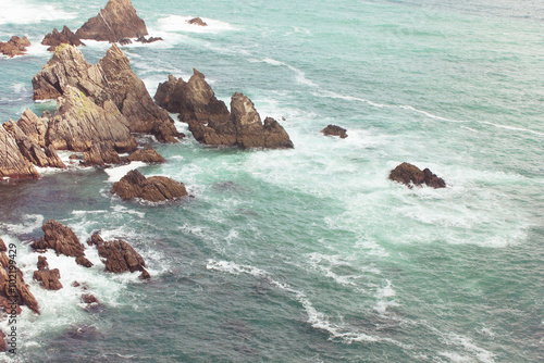 Loiba Cliffs. Waves and stones at sea. photo
