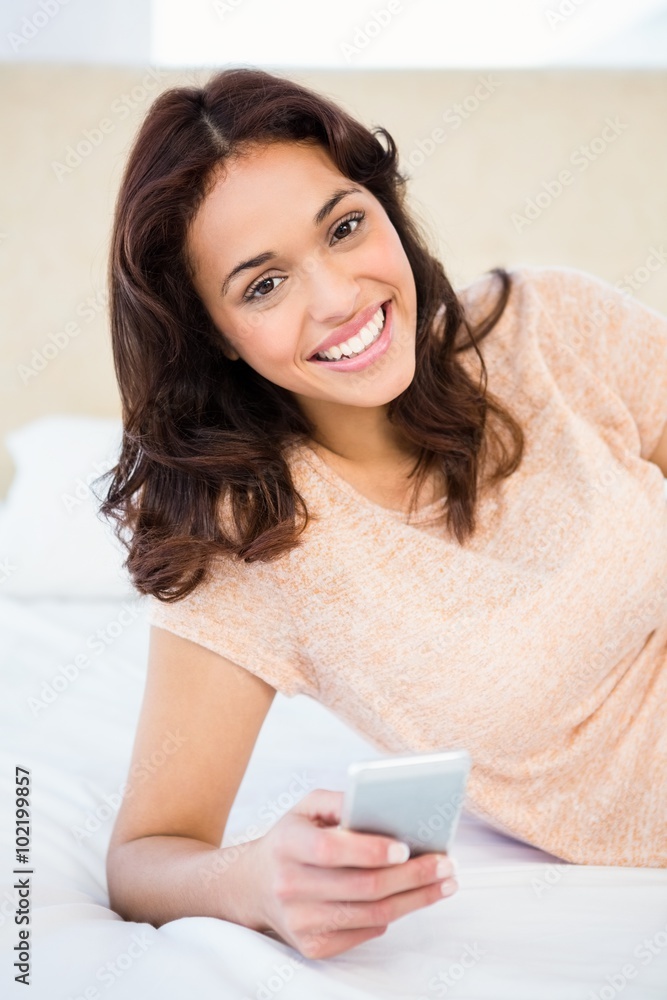 Casual smiling woman using her smartphone Casual smiling woman using her smartphone