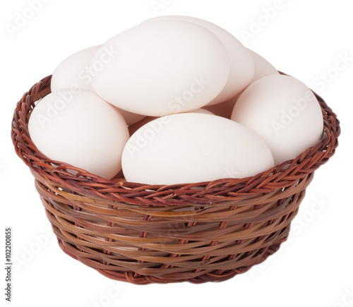 basket with goose eggs on a white background