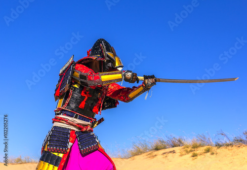 Samurai in ancient armor, with a sword in an attack