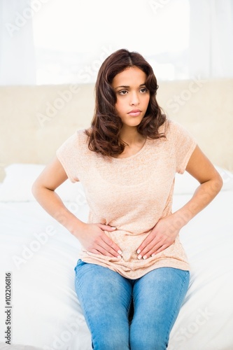 Casual smiling woman touching her belly