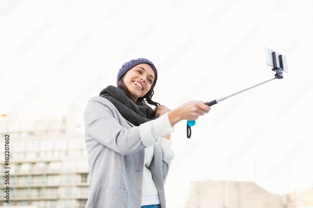 Happy woman using selfie stick Happy woman using selfie stick