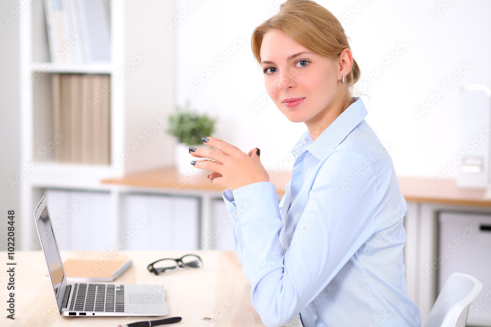 Young blonde business woman with laptop in the office. Business concept. Young blonde business woman with laptop in the office. Business concept.