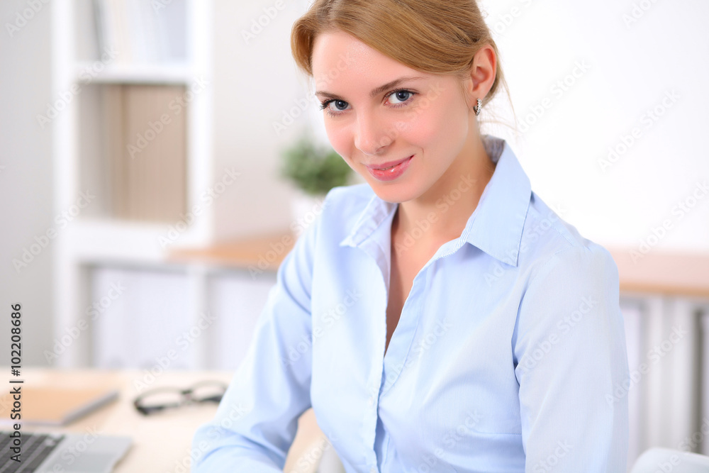 Young blonde business woman with laptop in the office. Business concept. Young blonde business woman with laptop in the office. Business concept.