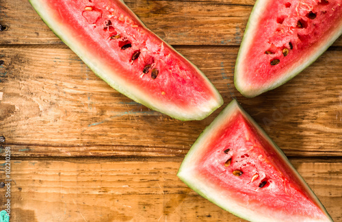 Slices of watermelon, top view, background. Summer fruit on wood