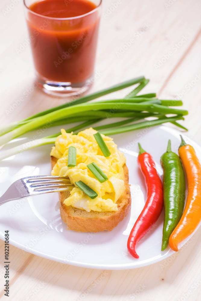American style scrambled eggs on toast with
a glass of juice
American style scrambled eggs on toast with
a glass of juice