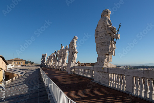 Back view of eleven statues of the saints apostles on the top of St Peter Basilica roof. Vatican City, Rome, Italy © Shchipkova Elena