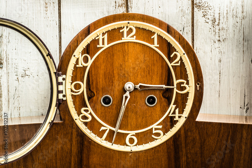 Photography Old vintage clock on wooden wall background.