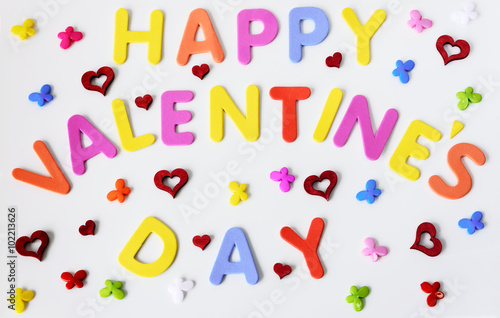 Text of colorful letters Happy Valentines day with multicolored small butterflies and red hearts