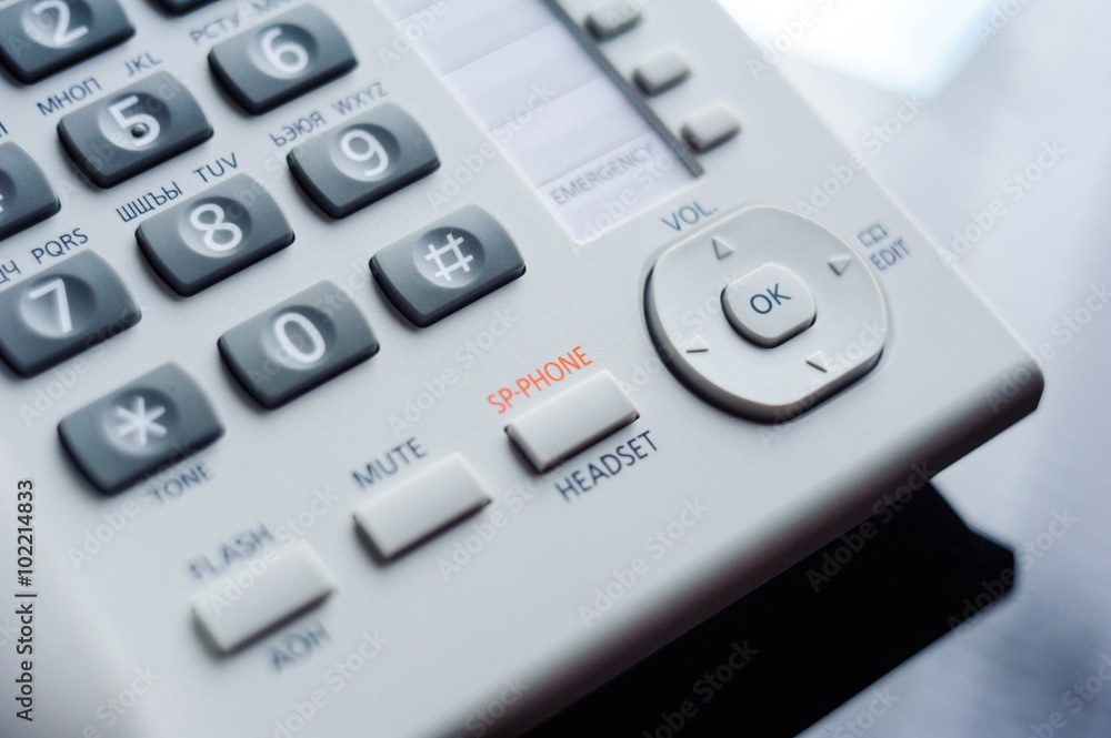 Detail of executive VoIP desk phone buttons. Shallow depth of field - focus on the center of the phone Detail of executive VoIP desk phone buttons. Shallow depth of field - focus on the center of the phone