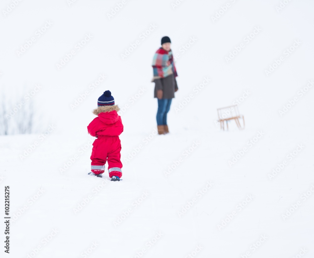 Boy and his mother playing in winter landscape. Child model Boy and his mother playing in winter landscape. Child model