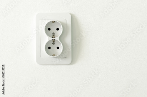 European white electrical outlet socket on white wall