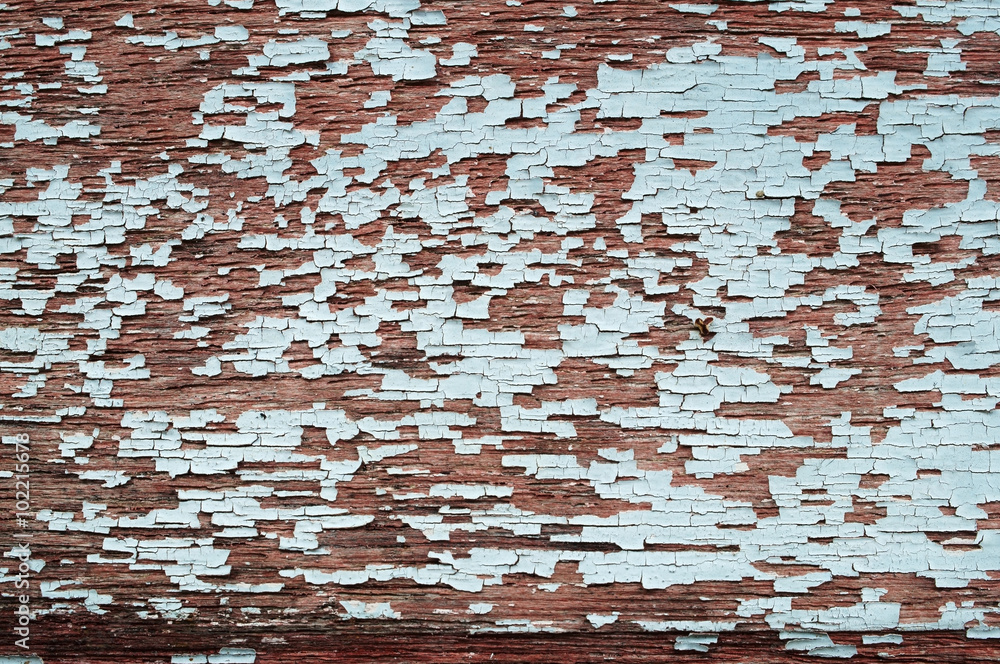 Peeling paint on weathered wood as a detailed background image Peeling paint on weathered wood as a detailed background image