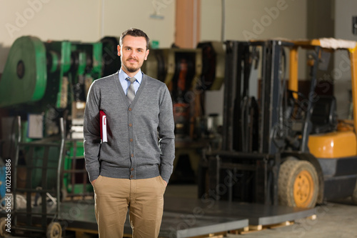 Young businessman in factory