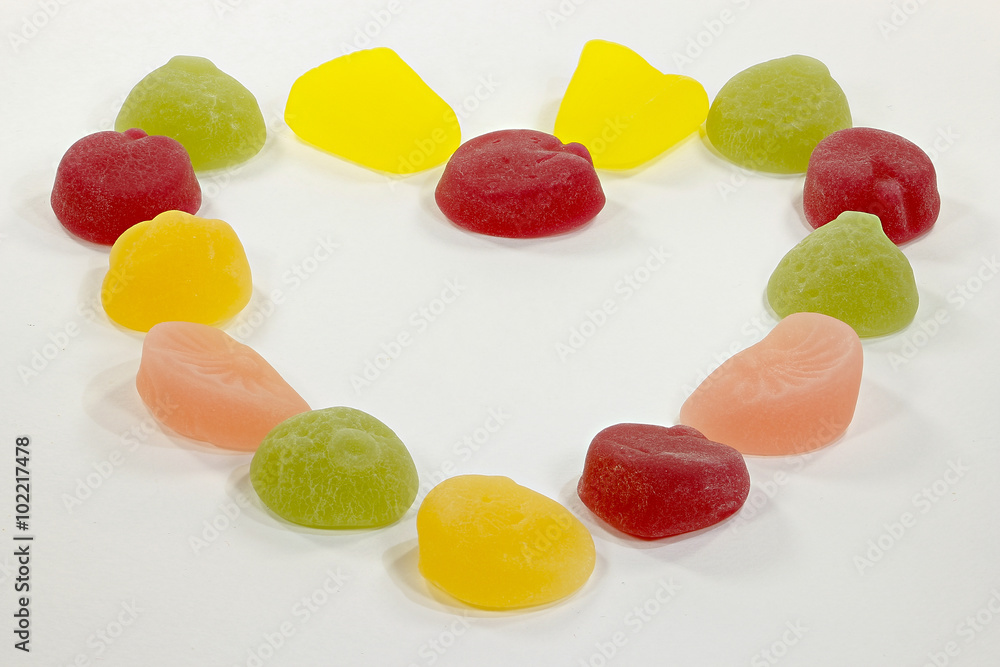 Colorful fruit candies arranged in the shape of heart Colorful fruit candies arranged in the shape of heart