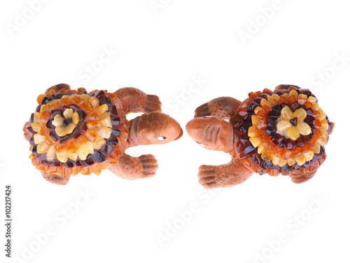 toy turtle with a shell made of amber on a white background
