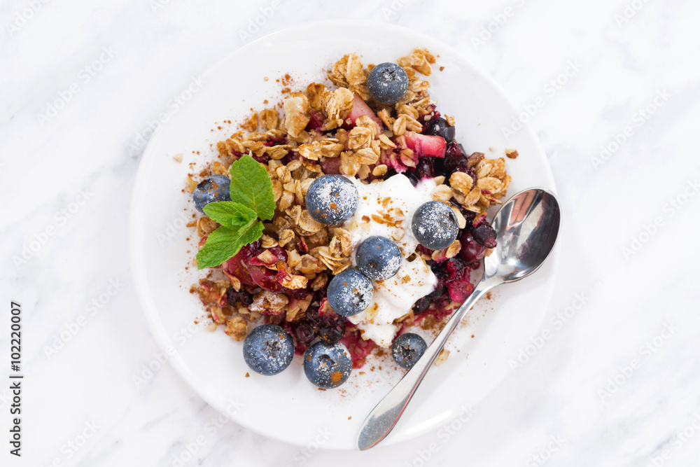 berry crumble with oat flakes on white table, top view, closeup berry crumble with oat flakes on white table, top view, closeup