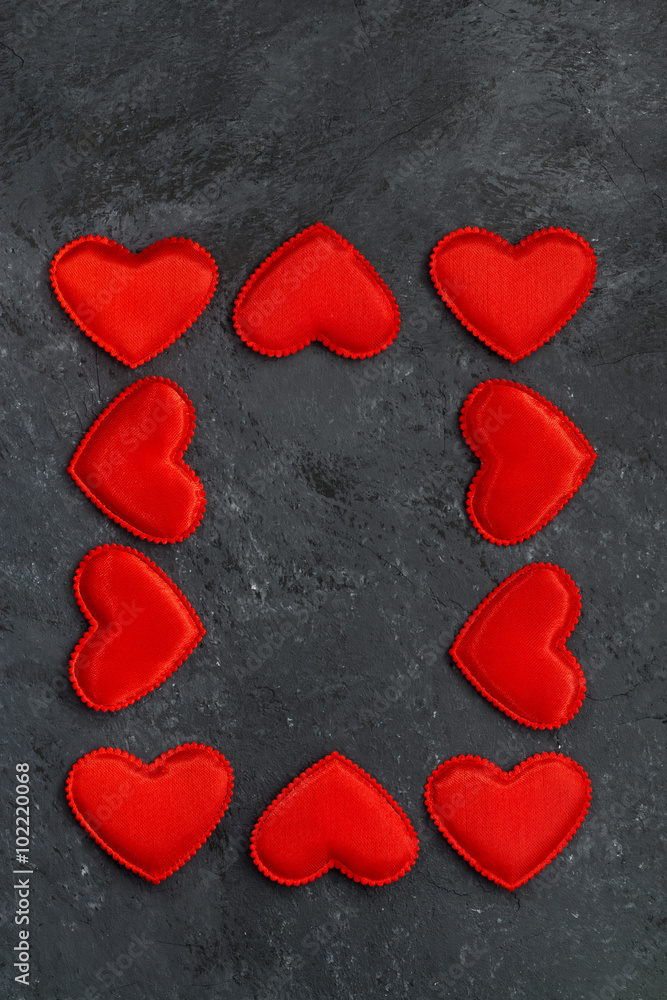 Fototapeta premium black background with frames of red hearts, vertical