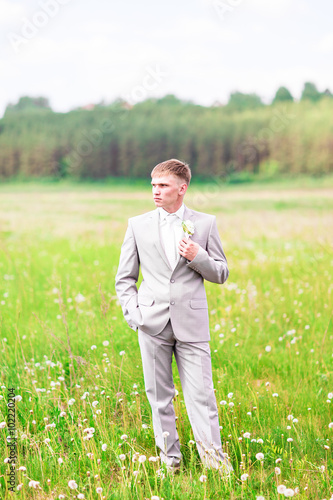 Portrait of the groom outdoors on their wedding day
