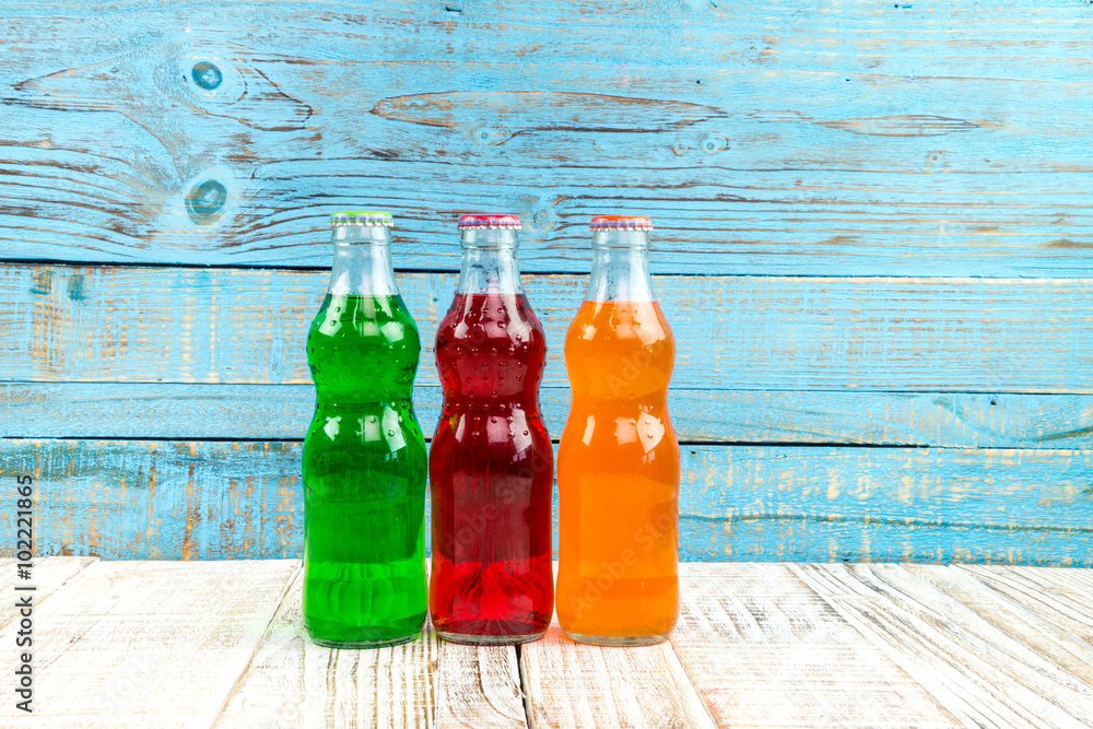 variety of soda bottle on the wooden background