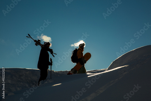 male skier carries skis in the snow on winter day at the ski resort in Georgia