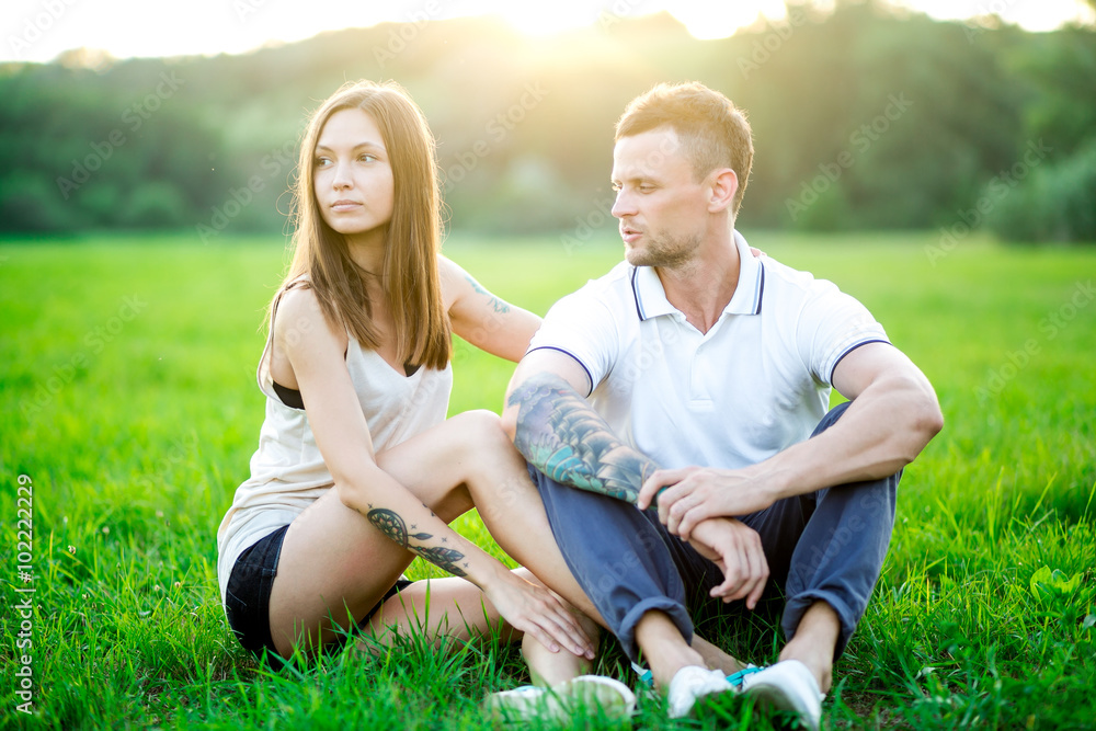 Couple in love - Beginning of a Love Story. A man and a girl with a tattoo on the nature Couple in love - Beginning of a Love Story. A man and a girl with a tattoo on the nature