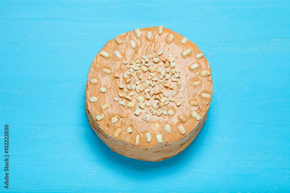 Homemade peanut cake on wooden background. Toned