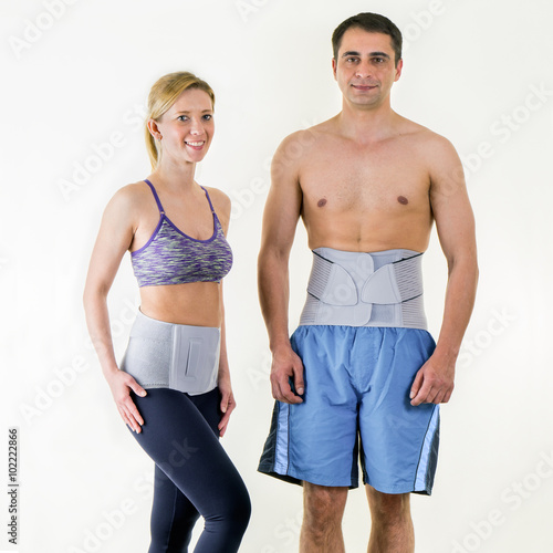 Athletic Man and Woman Wearing Back Support Braces.