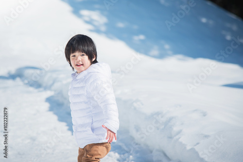 asian boy in winter clothes with snow background