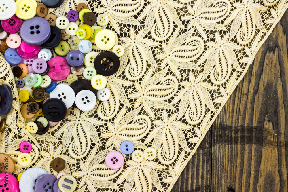 Naklejka premium Buttons on cream lace