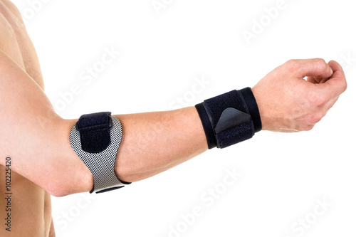 Man Wearing Wrist and Elbow Braces in Studio. photo