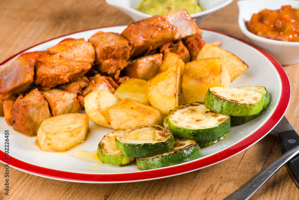skewered meat and vegetables on wooden plate skewered meat and vegetables on wooden plate