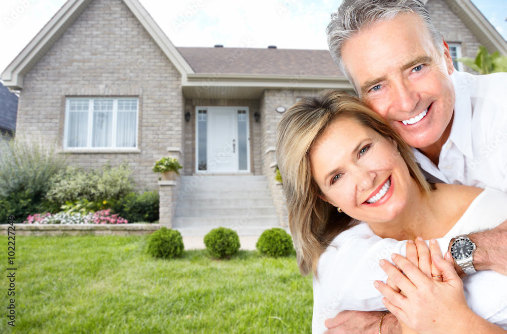 Happy senior couple near new house. Happy senior couple near new house.