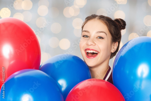 happy teenage girl with helium balloons