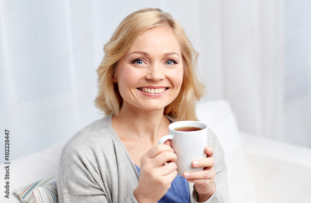 smiling woman with cup of tea or coffee at home smiling woman with cup of tea or coffee at home