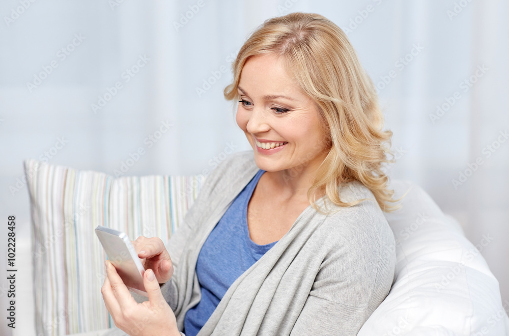 smiling woman with smartphone texting at home smiling woman with smartphone texting at home